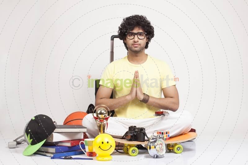 boy surrounded by things sitting and posing 