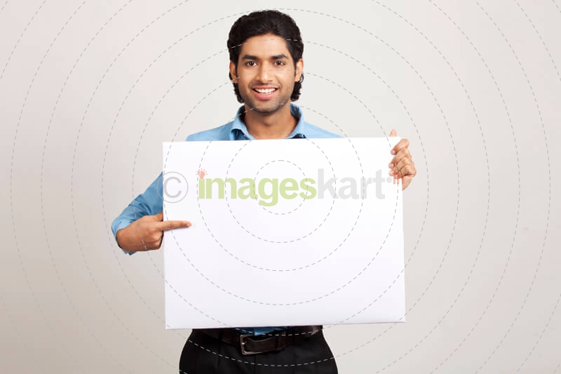 man pointing towards placard