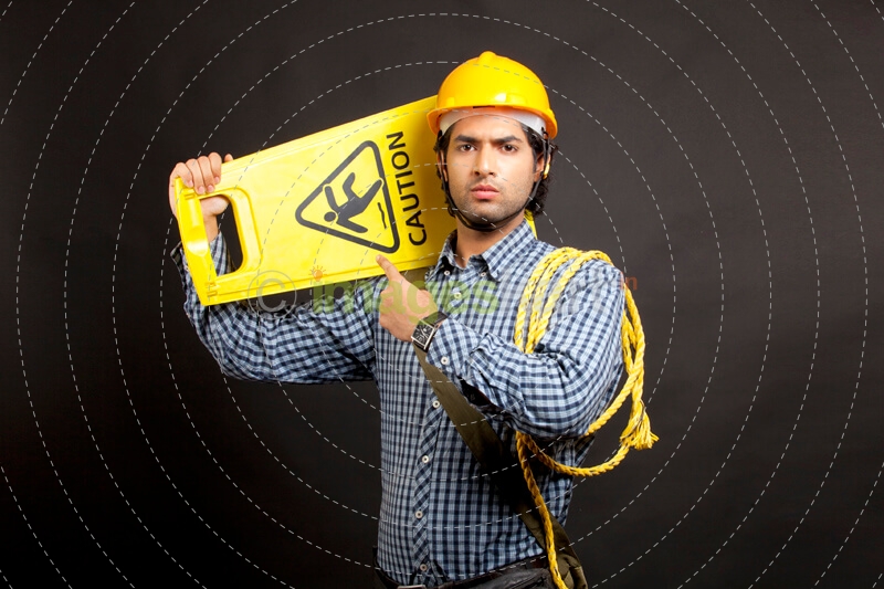 man pointing at the caution board