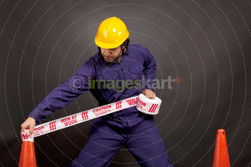 man applying caution tape
