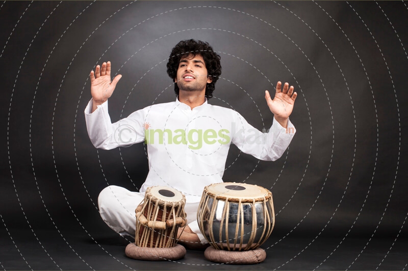 man playing classical music on tabla 