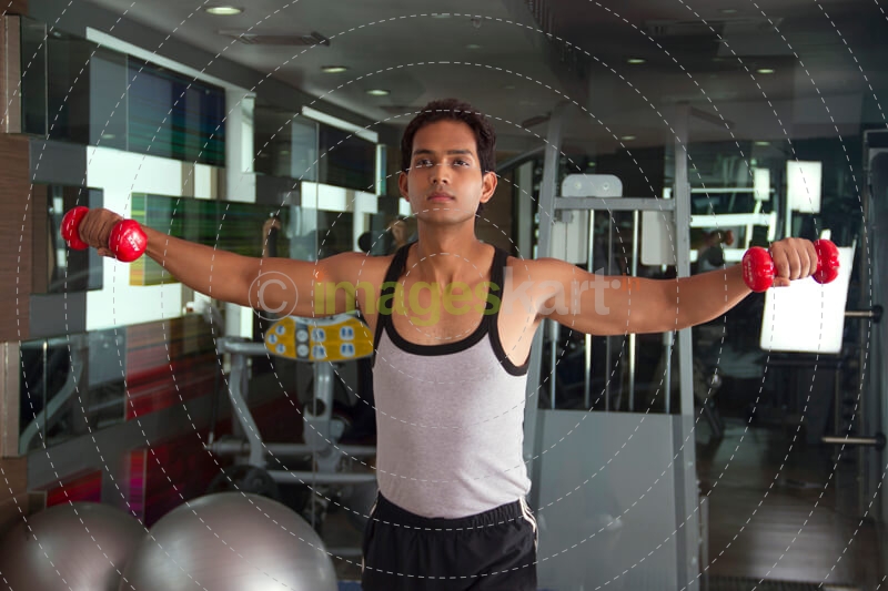 guy with determination working out in the gym