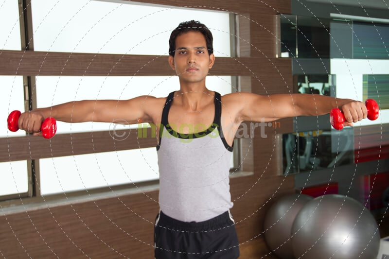 young guy exercising at the gym