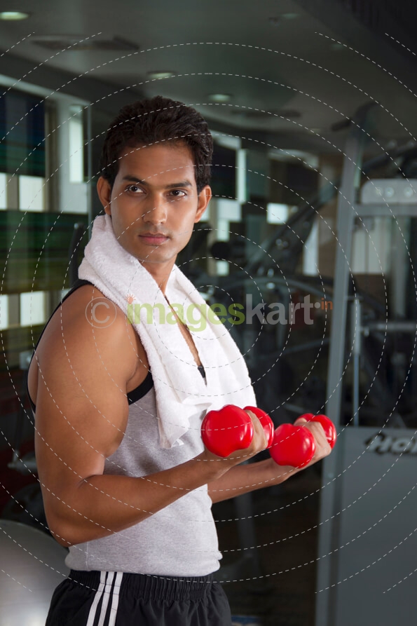 guy working out with red coloured dumbbells