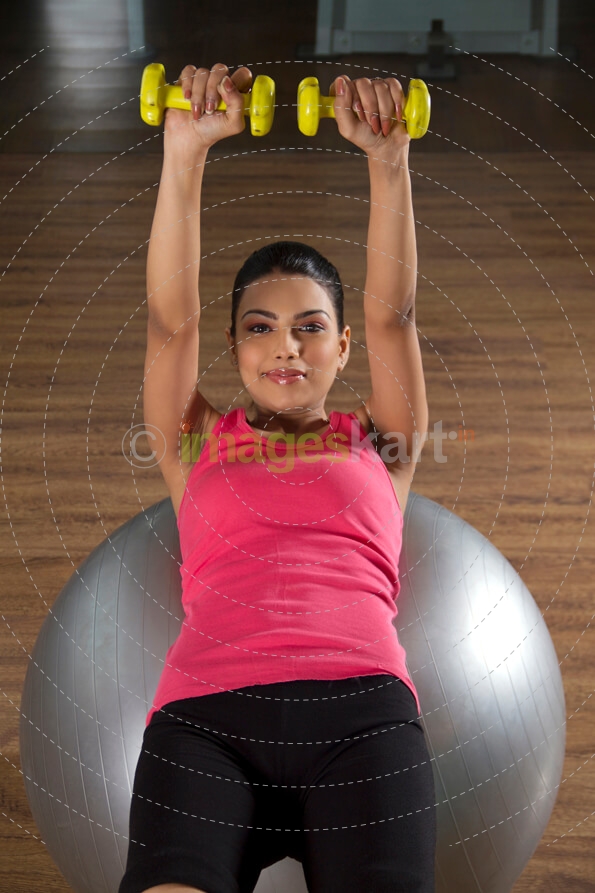 young happy teenager working out in the gym