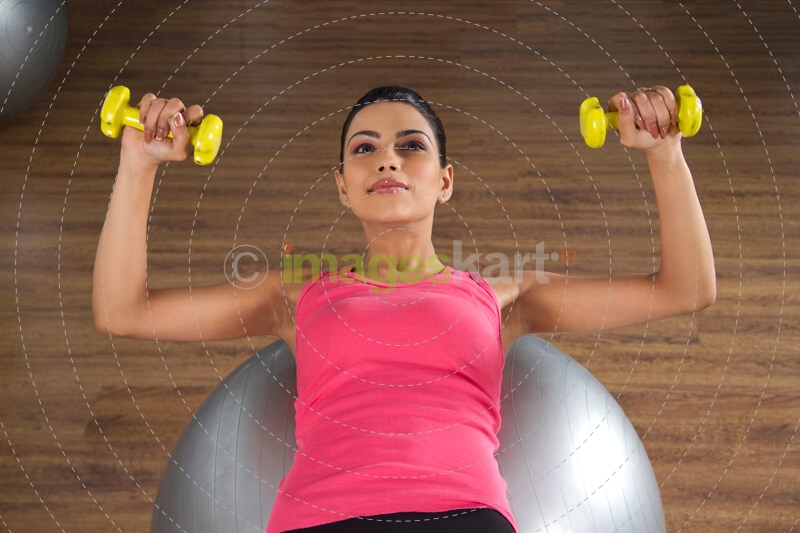 attractive female getting in shape on a fitness ball