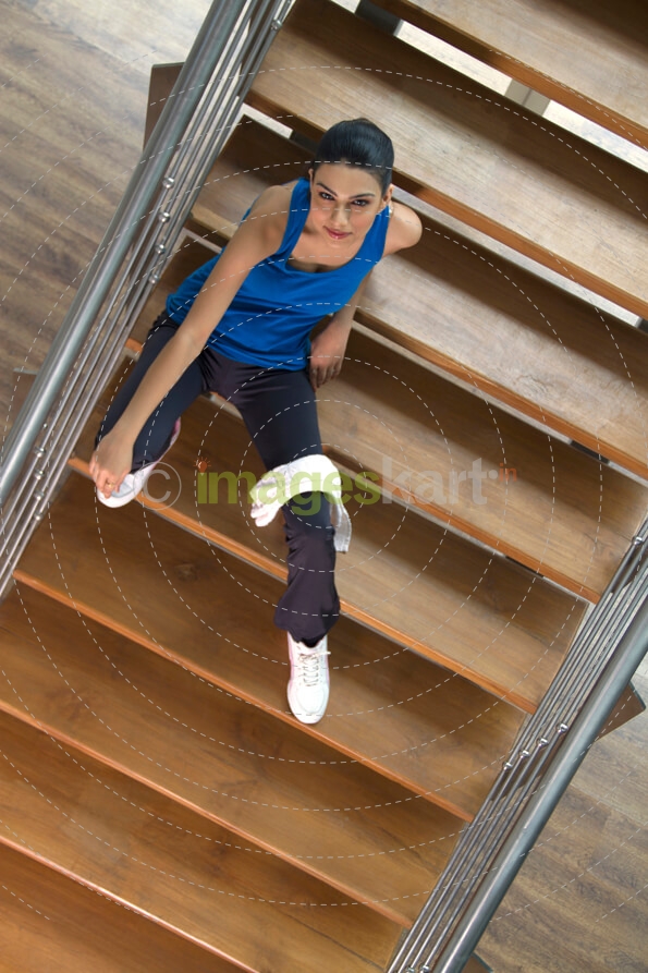 girl sitting on the stairs of a gym
