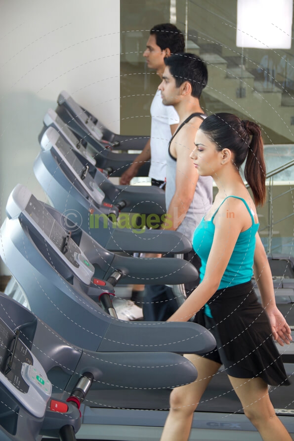 side view of three people at the treadmill 