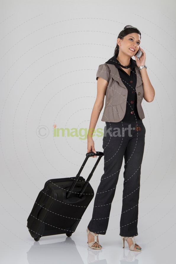 woman with luggage and phone