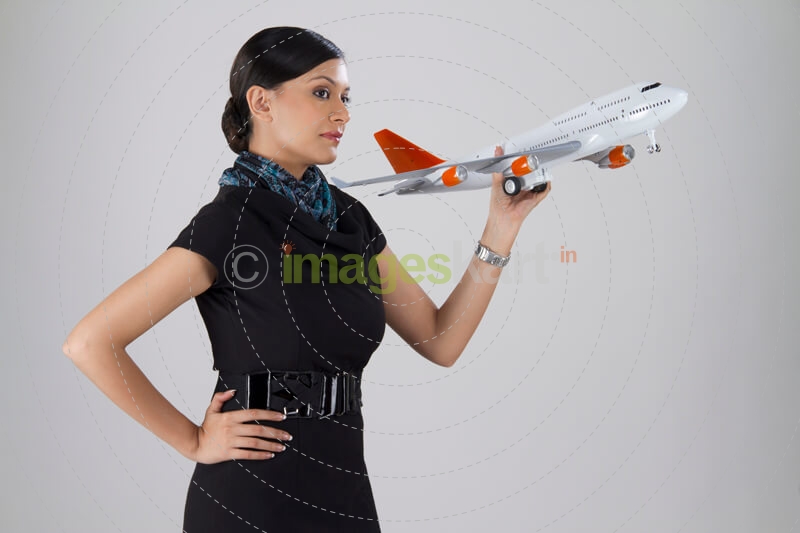side pose of a woman posing with an airplane