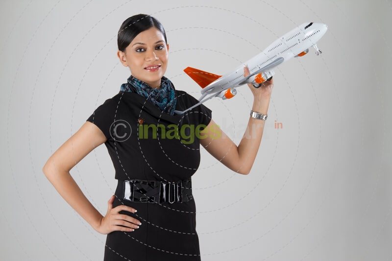 stylish woman with an airplane toy