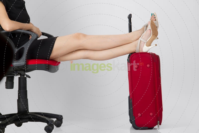 woman sitting with a travel bag