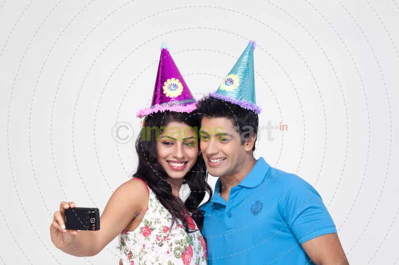 couple smiling while taking their picture from mobile camera 