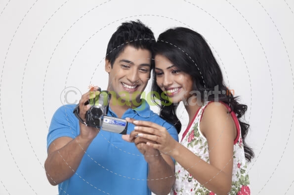 couple looking at video recorder
