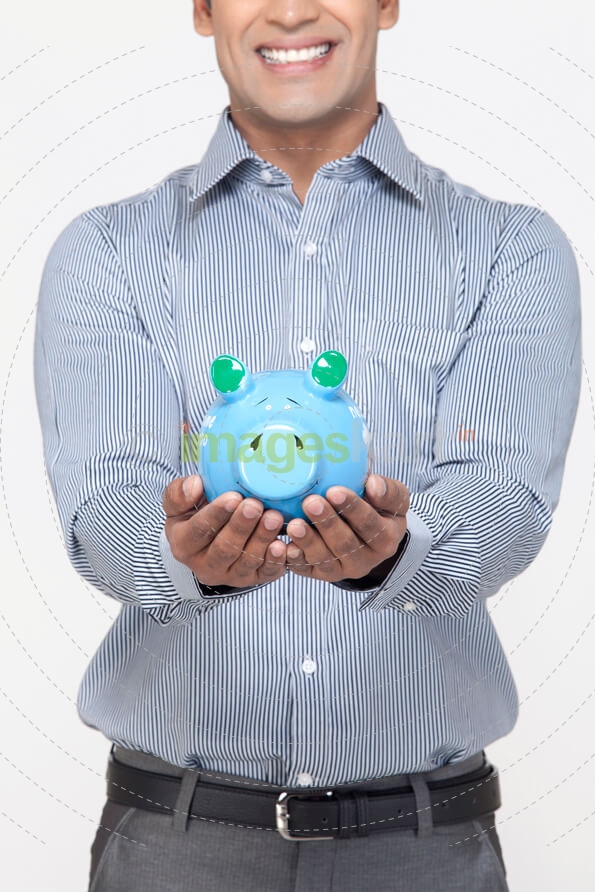 smiling man with piggy bank against white background