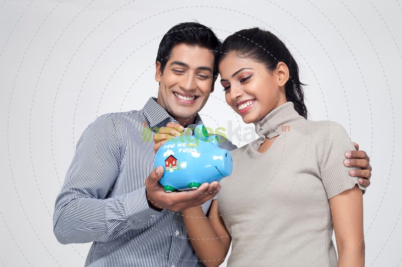 couple holding piggy bank and smiling