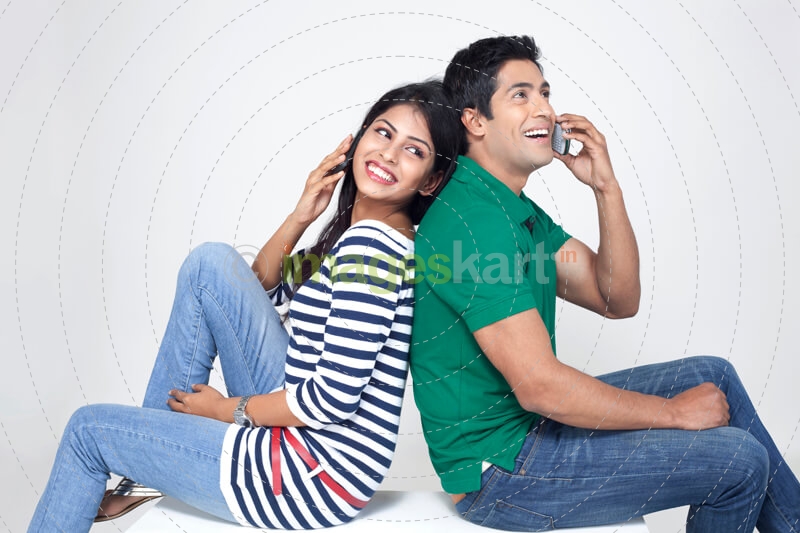 cheerful couple talking on the phone