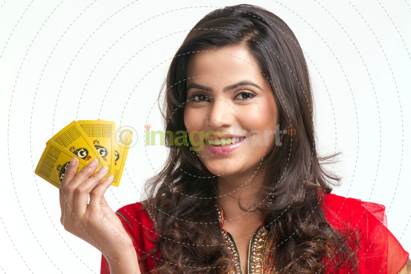 woman smiling and posing with playing cards