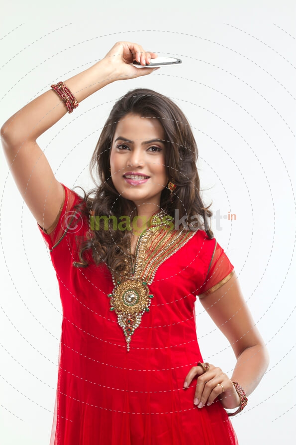 woman in ethnic wear with mobile phone