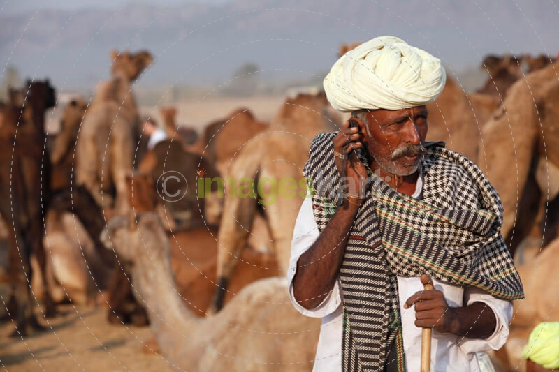 rural mean wearing turban talking on phone 