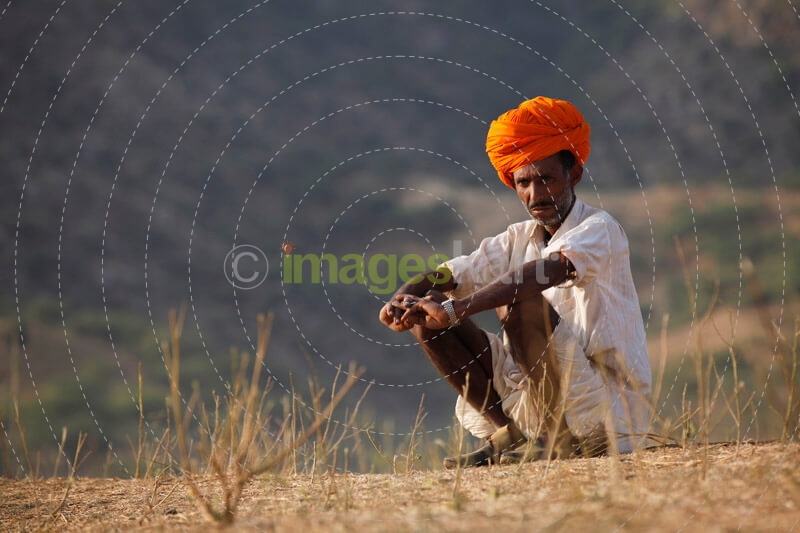 rural man sitting in the field