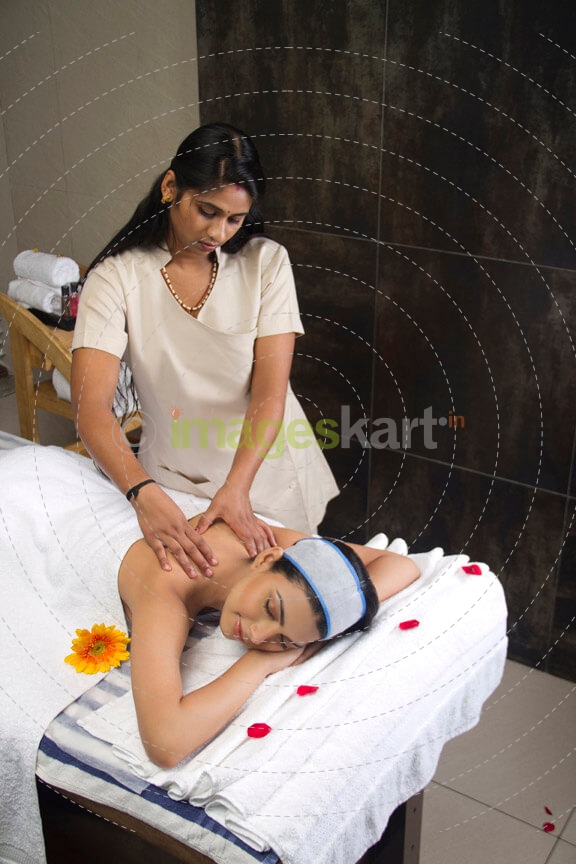 therapist giving body massage