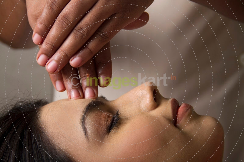 woman taking head massage