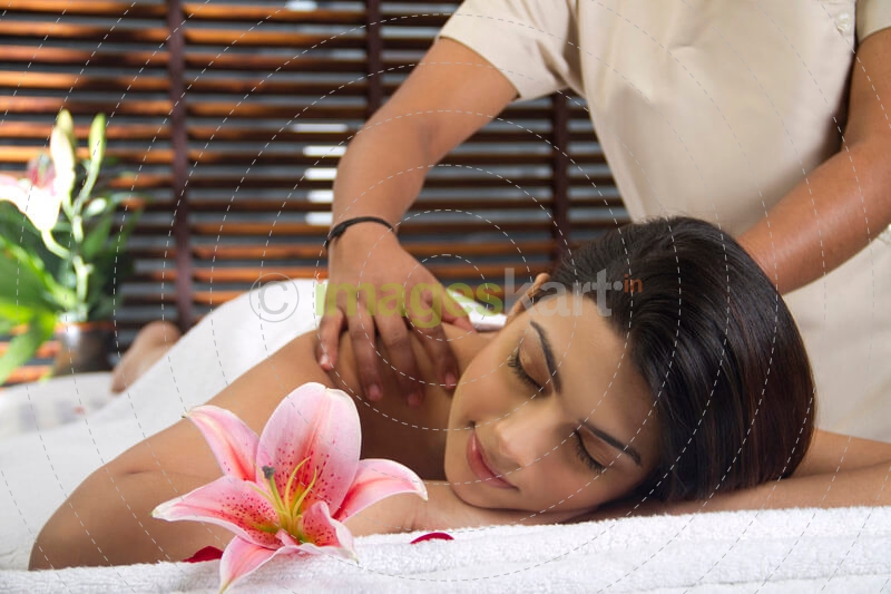 woman taking massage at spa centre