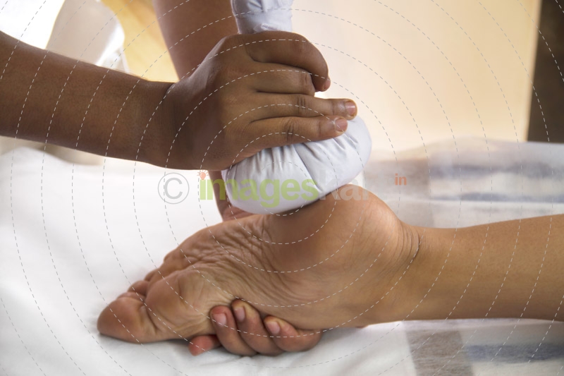 woman taking leg massage at spa center 