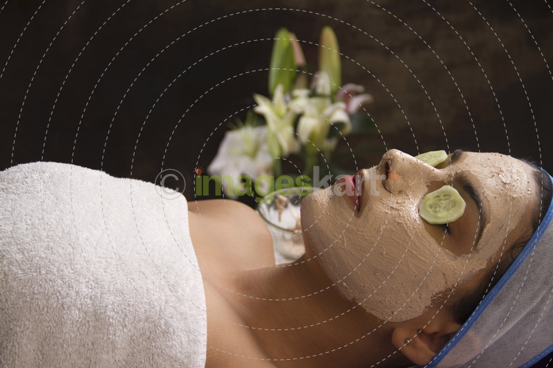 girl lying down with facepack on her face 