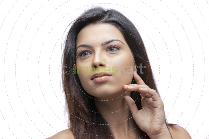 portrait of a pretty girl with finger on her face