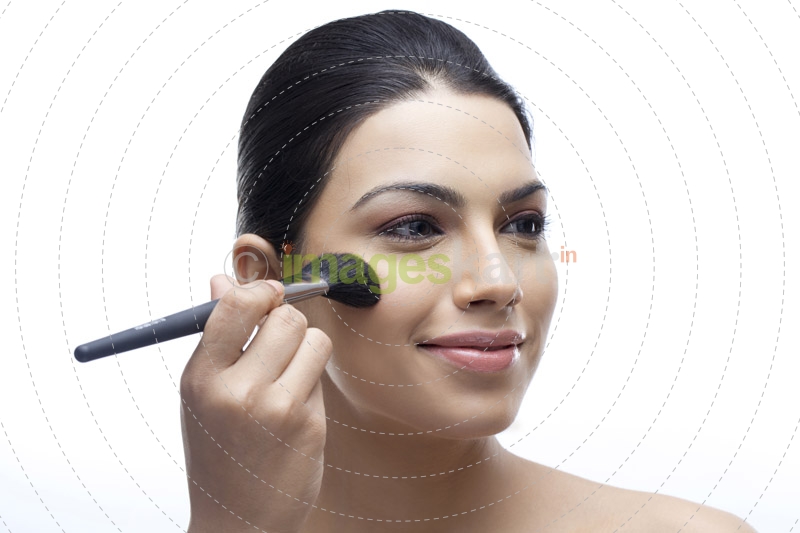 close-up of woman applying blush