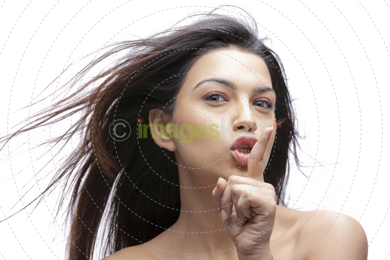 beautiful woman with finger on lips