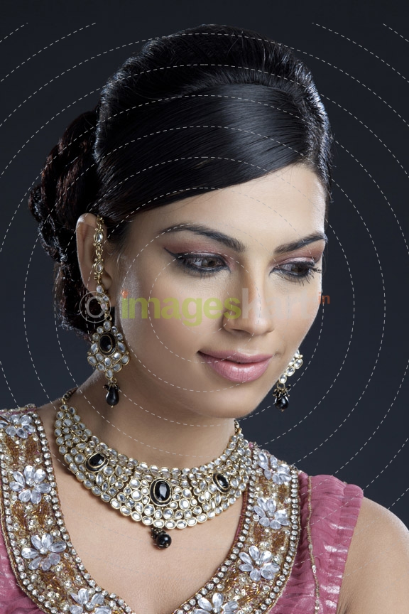 shy woman posing wearing jewellery 