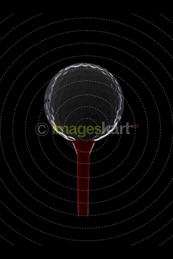 golf ball on golf tee with dark background 