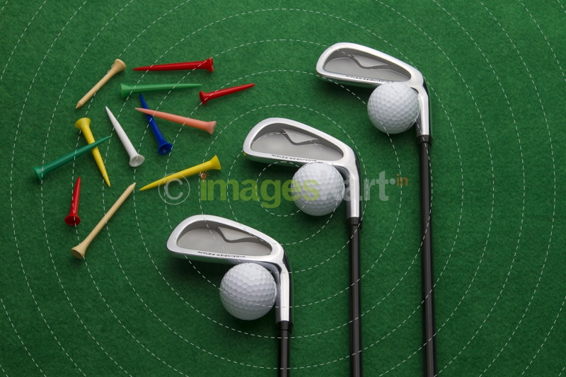 different golf accessories on green background