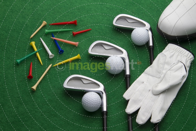 different golf accessories on green background