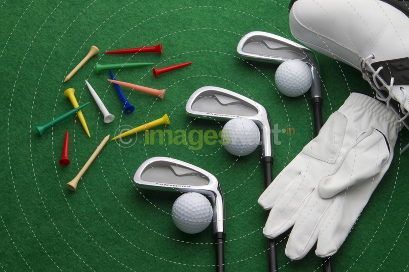 golf accessories on green background