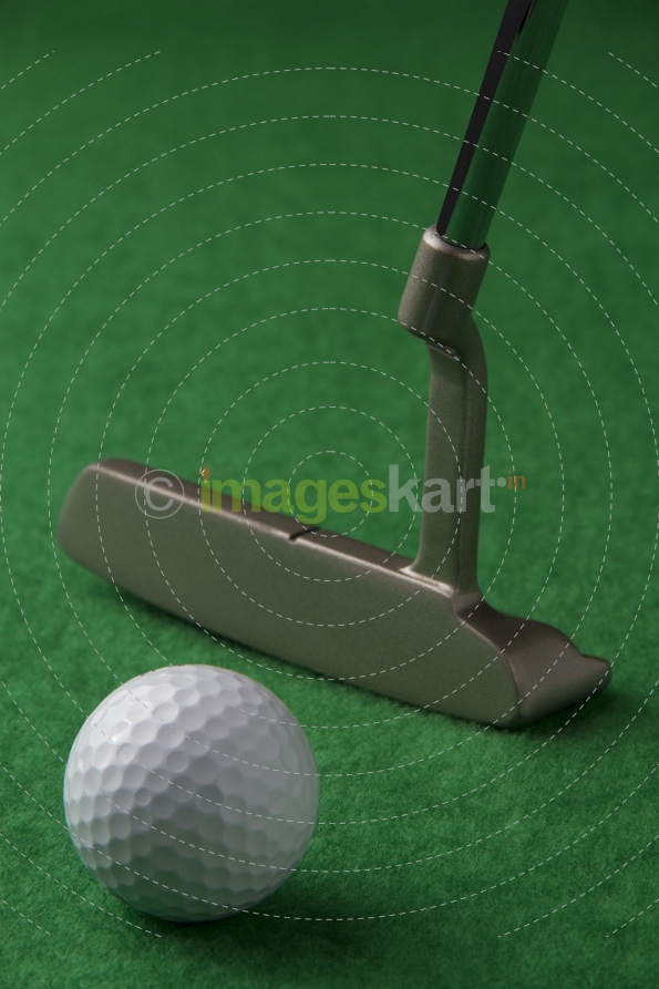 golf club and golf ball on a green background
