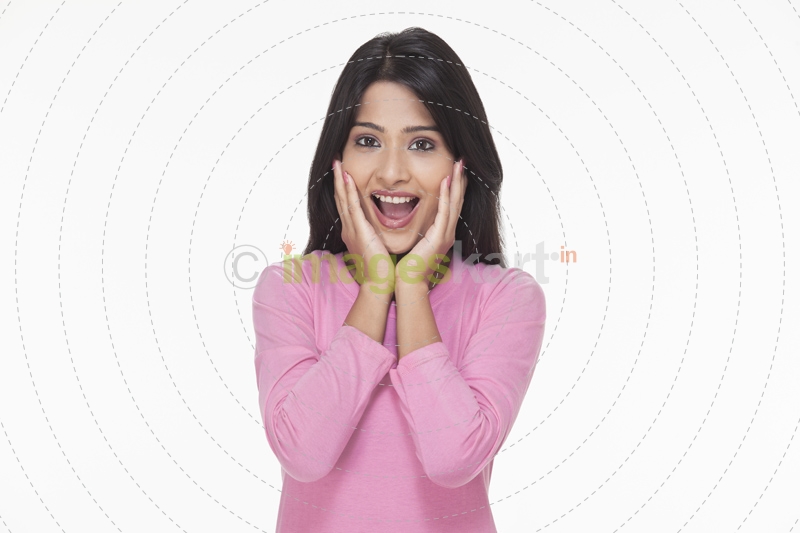surprised woman with her hands on face 