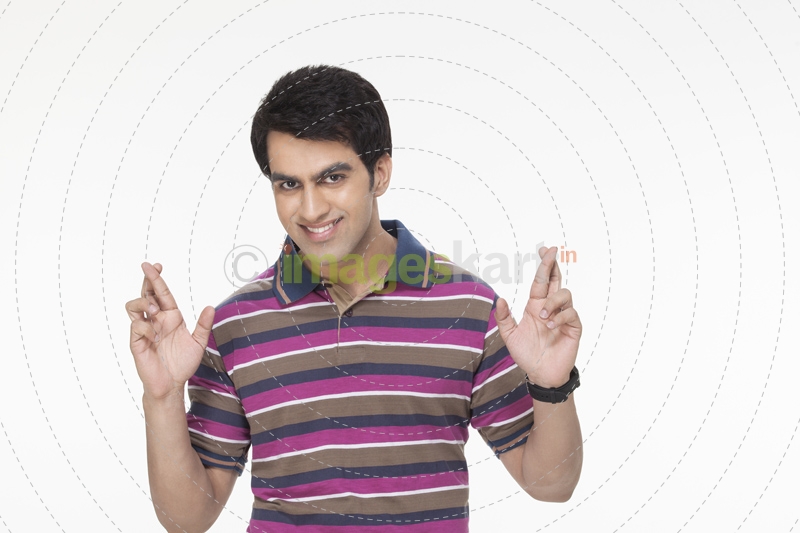 young man posing with fingers crossed