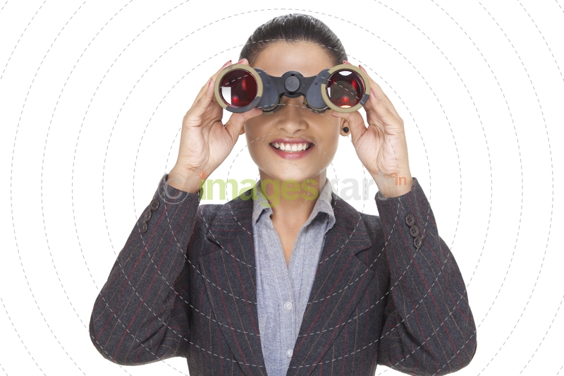young businesswoman watching with binocular 