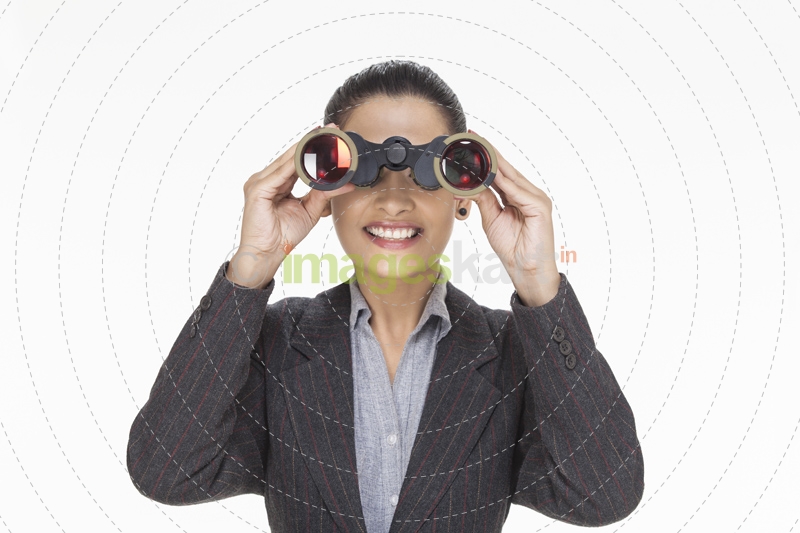 woman smiling while looking with binocular 