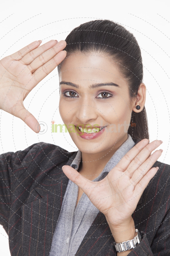 close up of a young business girl posing while framing with hands 