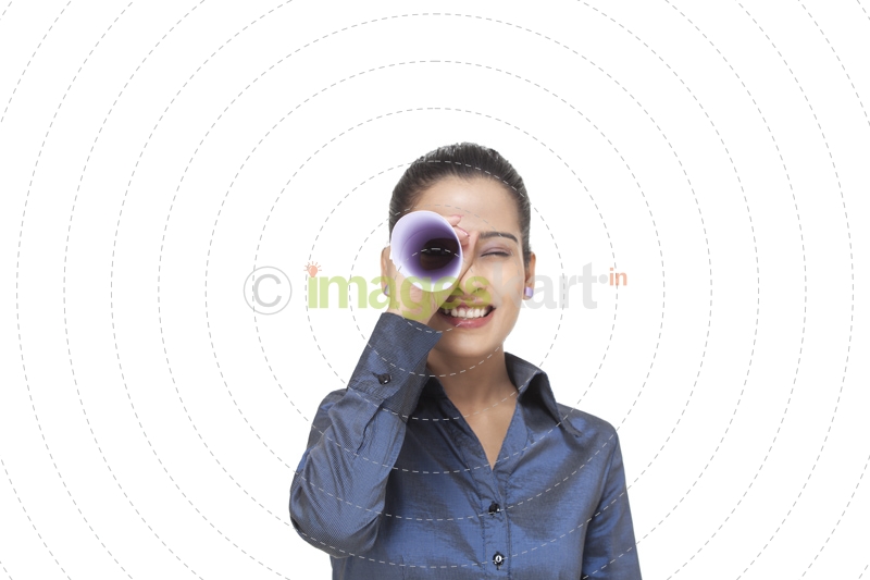 girl looking at the front through rolled sheet of paper 