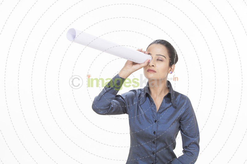 girl looking through rolled chart paper