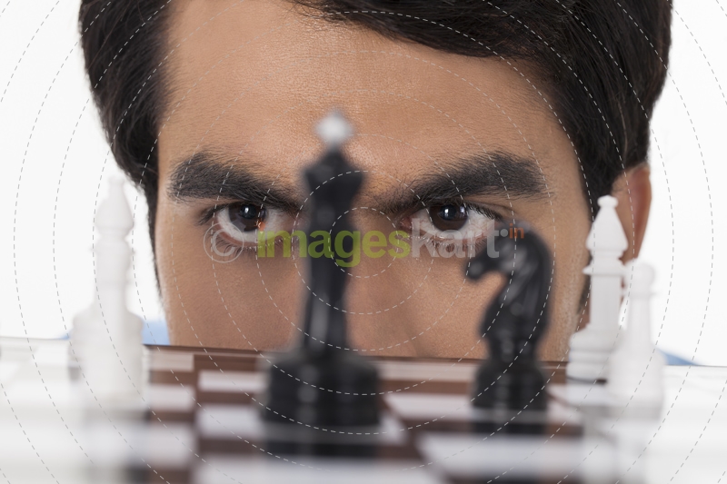 man looking at chess