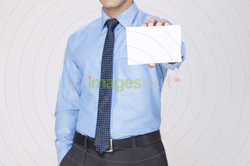 man holding white placard with one hand and other hand in pocket 