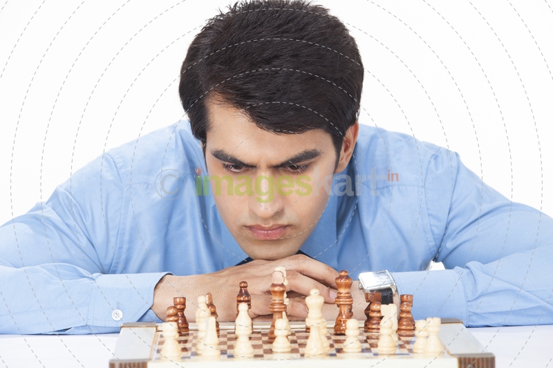 young businessman looking at chess board in deep thinking