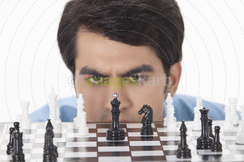 man thinking while playing chess 